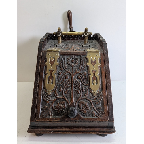 393 - Victorian Carved Coal Scuttle with Brass Mounts and Scoop

Victorian carved wooden coal scuttle of s... 