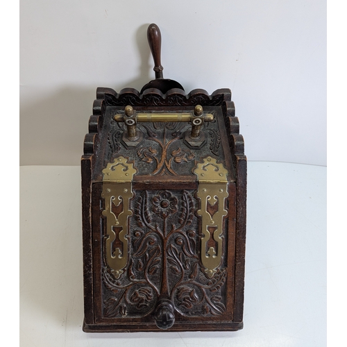 393 - Victorian Carved Coal Scuttle with Brass Mounts and Scoop

Victorian carved wooden coal scuttle of s... 