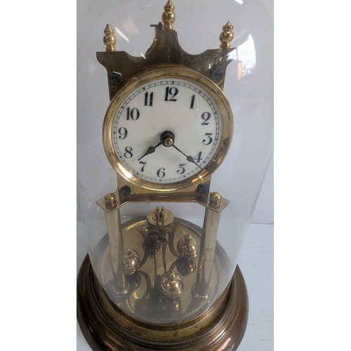 37 - Antique Brass Four-Glass Anniversary Torsion Clock Under Glass Dome

Porcelain dial with Arabic nume... 