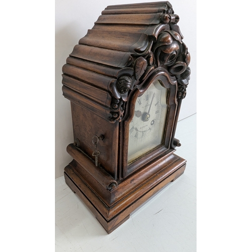 42 - Antique Carved Walnut Bracket Clock

Ornately carved case with prominent floral and foliate decorati... 