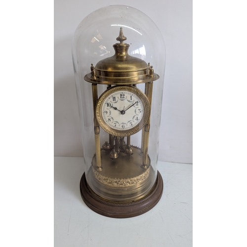 44 - Antique Brass Four-Glass Anniversary / Torsion Clock Under Glass Dome

Decorative enamel dial with A... 