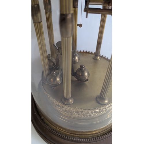 44 - Antique Brass Four-Glass Anniversary / Torsion Clock Under Glass Dome

Decorative enamel dial with A... 