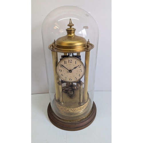 45 - Antique Brass Four-Glass Anniversary / Torsion Clock Under Glass Dome

Cream dial with stylised Arab... 
