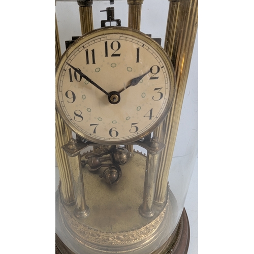 45 - Antique Brass Four-Glass Anniversary / Torsion Clock Under Glass Dome

Cream dial with stylised Arab... 