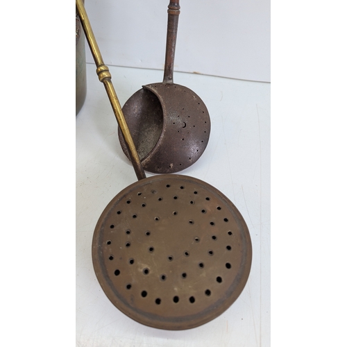 52 - Collection of Antique Brass & Iron Hearth / Kitchen Utensils

Comprising a large brass cauldron or p... 