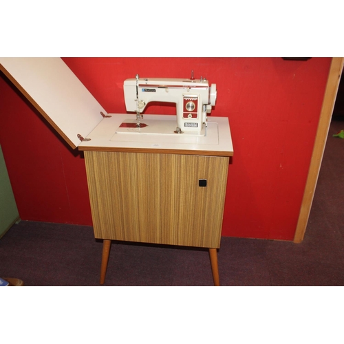 37 - 1 x newhome electric sewing machine with sewing machine cabinet