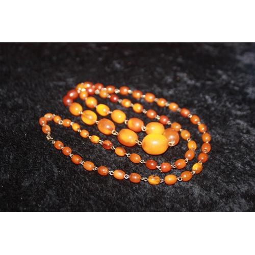 104 - 1 x amber necklace contains 65 various size beads 42 inches in total