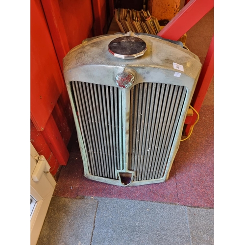 35 - One vintage triumph car radiator and grill cover