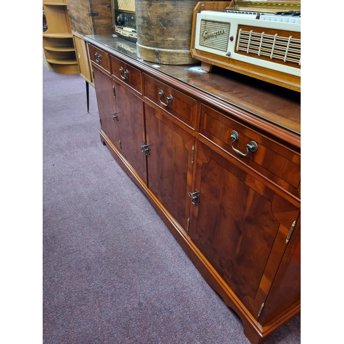 55 - One reproduction four drawer four-door sideboard unit