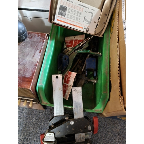 29 - Plastic tub containing various clamps etc...