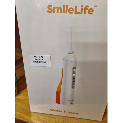 375 - 1x smilelife electric water flosser (sealed in box)