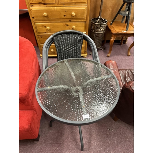 69 - 1x metal and glass topped garden table with four rattan chairs