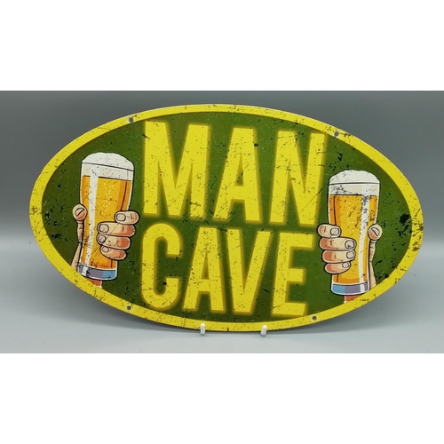 124 - 'Man Cave' Metal Sign. Length 35.5cm