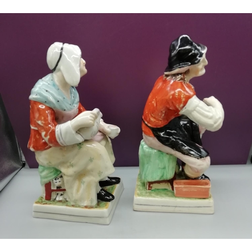 65 - Old Staffordshire Figures of 'Nell' and 'Jobson'. 31 cm High. Both have hairline cracks.