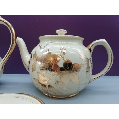 556 - Sadler Gold Embossed Teapot, Water Jug and Pot Stand.