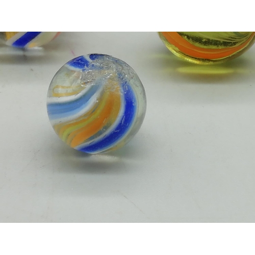 210 - Victorian Glass Multi Coloured Swirl Marbles (15) plus 4 Other Marbles in Tin. All proceeds from thi... 