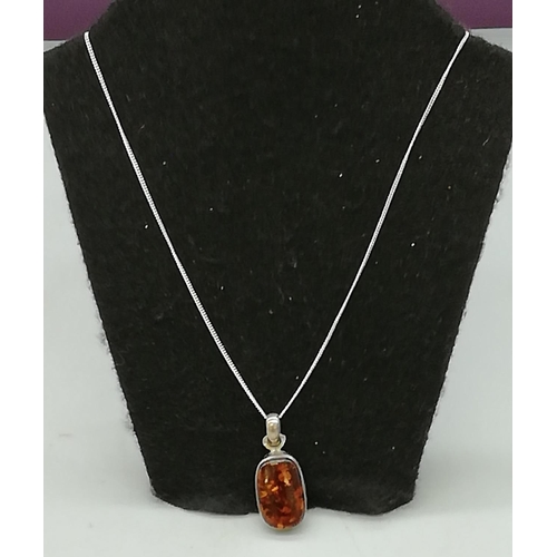 32 - Sterling Silver and Amber Pendant.