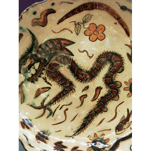 409 - Australian Folk Art Studio Pottery Plate with Mythical Beast Design. Nibble to Rim. 25cm Diameter.