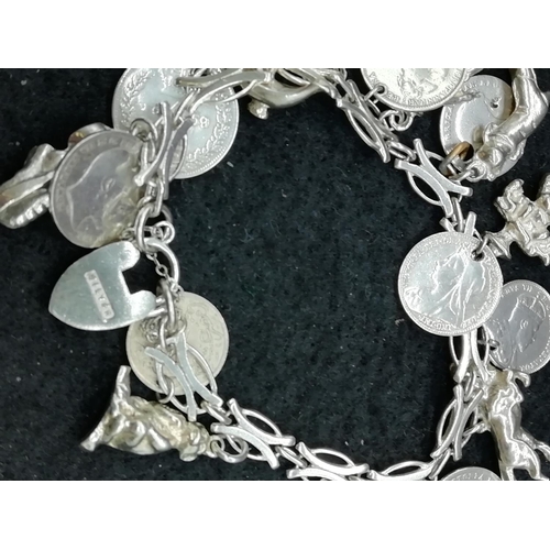 68 - Silver 3d Coins plus Charms Bracelet.