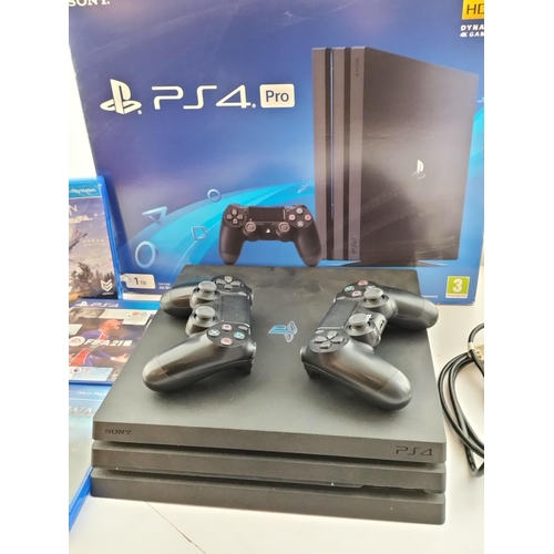 65 - Boxed Playstation 4 Pro, 1TB plus Controllers (2) and Games (3).