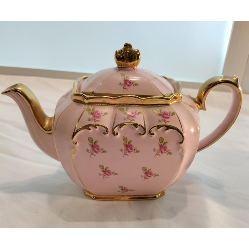 19 - Pink and Gilded Sadler Teapot with Rose Design. Chip Under Spout. 15cm High, 25cm x 11cm.