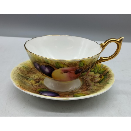 57 - Aynsley 'Fruit Design' Cup and Saucer. Signed N Brunt.