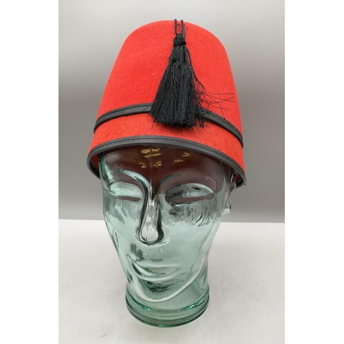 902 - Glass Mannequin 26cm Head plus Fez Hat.