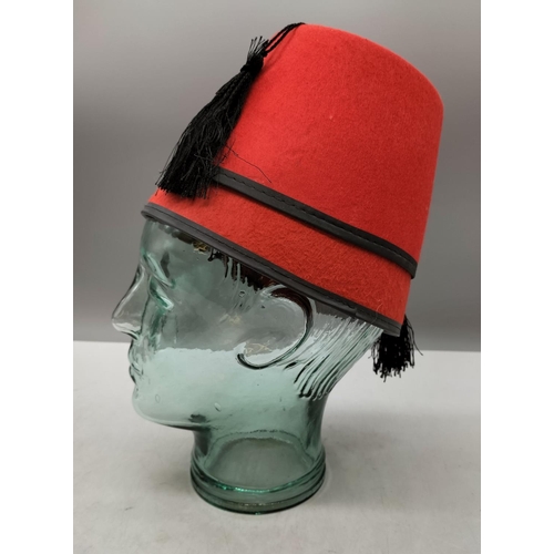 902 - Glass Mannequin 26cm Head plus Fez Hat.