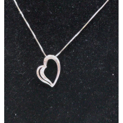 7 - 9ct White Gold and Diamond Heart Necklace.