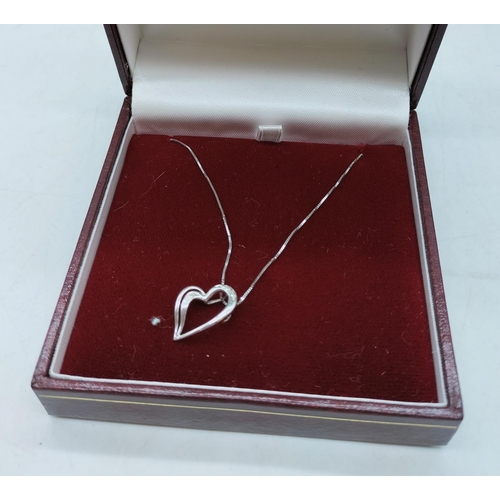 7 - 9ct White Gold and Diamond Heart Necklace.