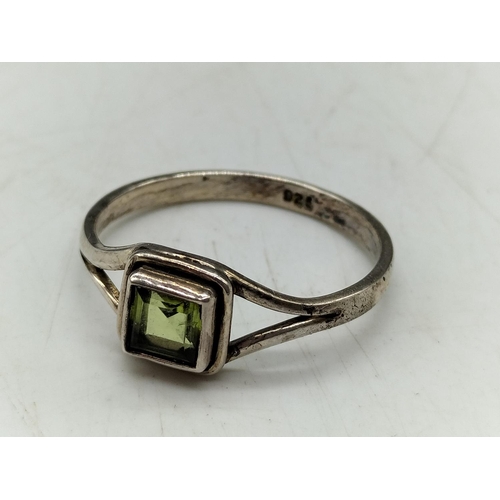 118 - 925 Silver and Peridot Ring. Size T.