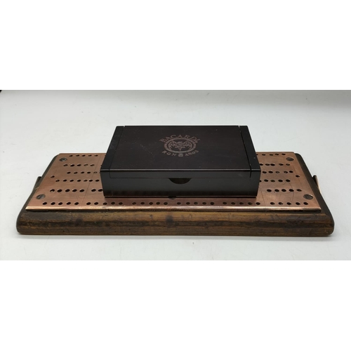 58 - Bacardi Brass Domino Set with Copper Topped Crib Board. 27cm x 12cm.