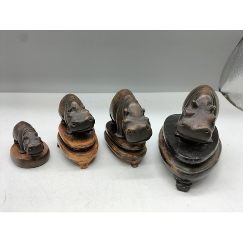 440 - Wooden Carved Hippos on Stands (4). Largest being 9cm x 5cm. 1 A/F.