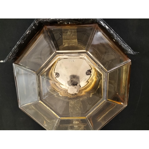 13 - Cast Aluminium Lamp with Amber Glass Octagonal Shade. 47cm x 24cm.