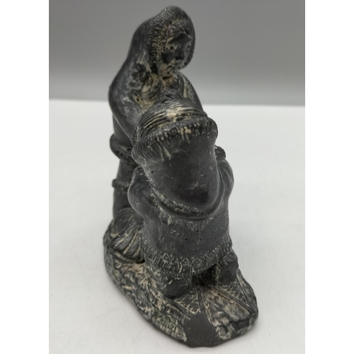 572 - A Wolf Original Sculpture of Inuit/Eskimos with Seal. 11cm x 12cm. Chip to Base but Displays Well.