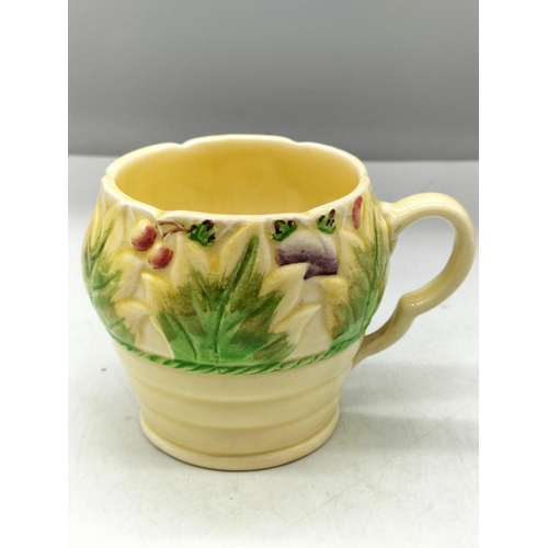 33 - Newport Pottery 8cm Clarice Cliff Mug.