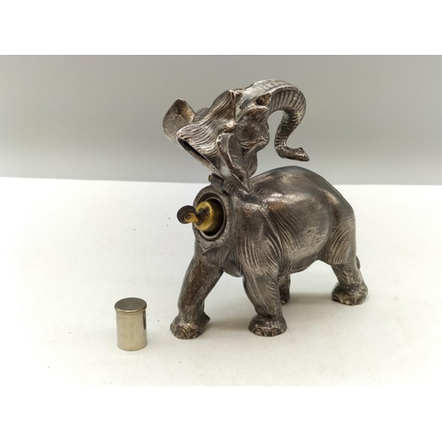 57 - White Metal Elephant Table Lighter. Requires Attention. 15cm x 12cm.