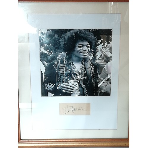 1 - Jimi Hendrix signed, A black and white photo of Hendrix framed and mounted with a cut autograph (pos... 