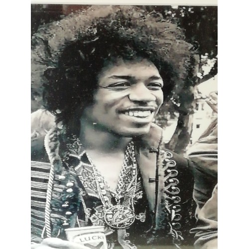 1 - Jimi Hendrix signed, A black and white photo of Hendrix framed and mounted with a cut autograph (pos... 