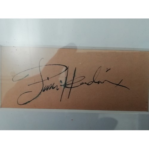 1 - Jimi Hendrix signed, A black and white photo of Hendrix framed and mounted with a cut autograph (pos... 