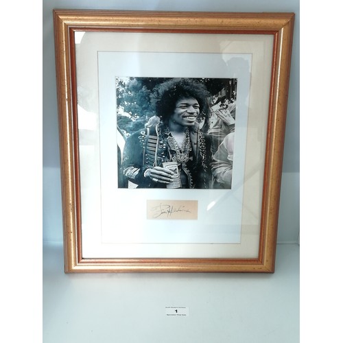 1 - Jimi Hendrix signed, A black and white photo of Hendrix framed and mounted with a cut autograph (pos... 