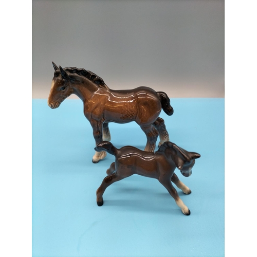 139 - Beswick Figures of Brown Foals (2). Largest being 13cm x 12cm.