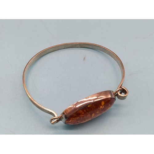 724 - 25 Silver and Amber Bangle.