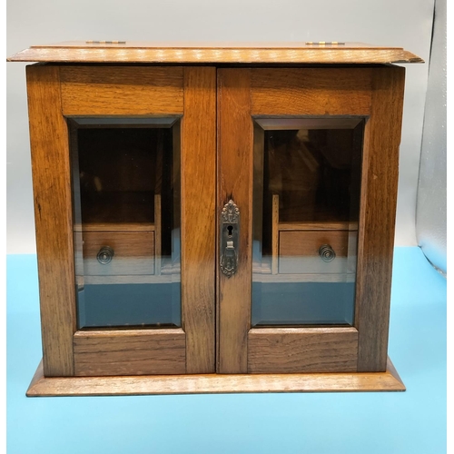 83 - Smokers Cabinet with Bevel Edged Glass and 2 Drawers. 32cm High, 35cm x 18cm. Requires Key. Slight D... 