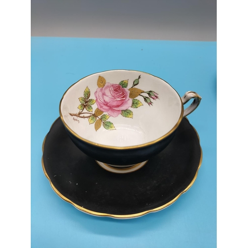 663 - Floral Bone China Cup and Saucer, signed Austin plus Royal Doulton 'Rosebud' Cup and Saucer.