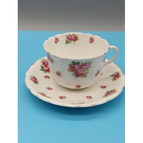 663 - Floral Bone China Cup and Saucer, signed Austin plus Royal Doulton 'Rosebud' Cup and Saucer.