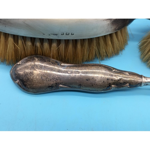 121 - Silver Topped Silver Brushes (2) plus Silver Handled Shoe Horn.