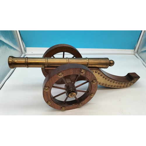 1 - Wooden Framed Brass Cannon. 57cm Long, 22cm High.