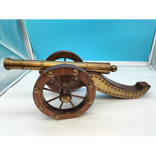 1 - Wooden Framed Brass Cannon. 57cm Long, 22cm High.