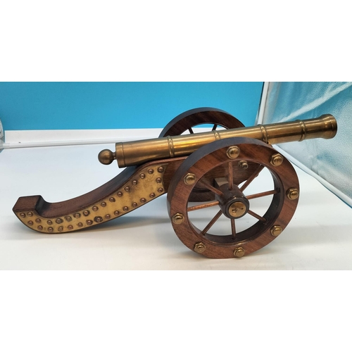 1 - Wooden Framed Brass Cannon. 57cm Long, 22cm High.